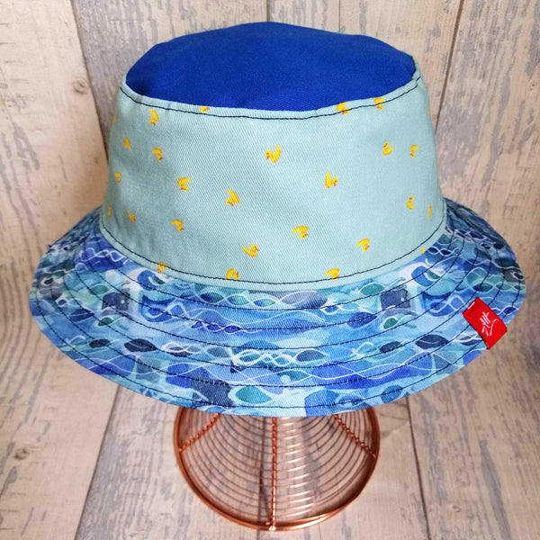 Reversible swimmer's festival bucket hat featuring a new waves design