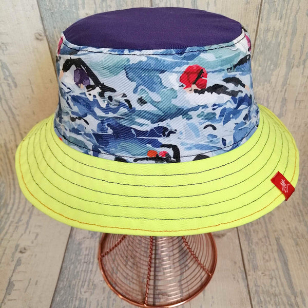 Reversible swimmer's festival bucket hat featuring swimmers