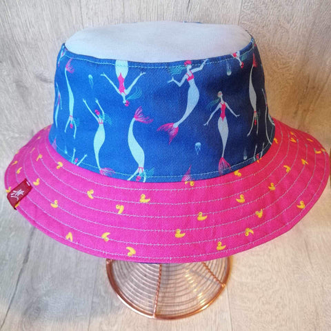 Reversible swimmer's festival bucket hat in bright pink with mini mermaids
