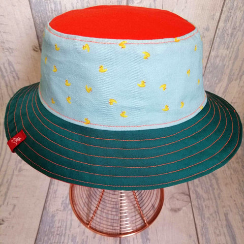 Reversible swimmer's festival bucket hat in forest green and neon orange