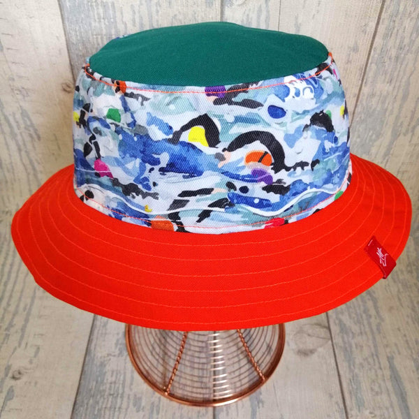 Reversible swimmer's festival bucket hat in forest green and neon orange