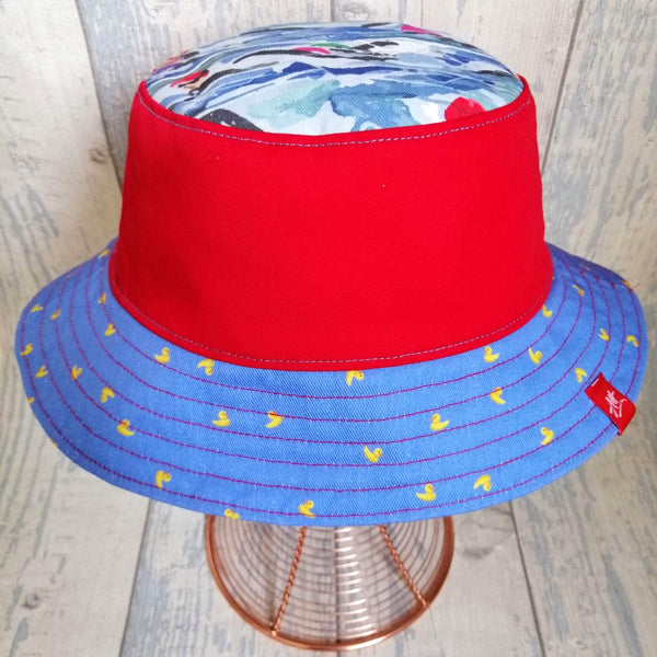 Reversible swimmer's festival bucket hat in cornflower blue, neon yellow and red