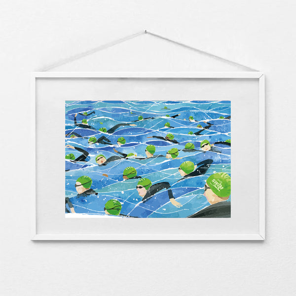 Framed A4 art print of the Great North Swim mass start, showing swimmers in green swim caps and wetsuits in open water. Print shown in a white frame (not included).