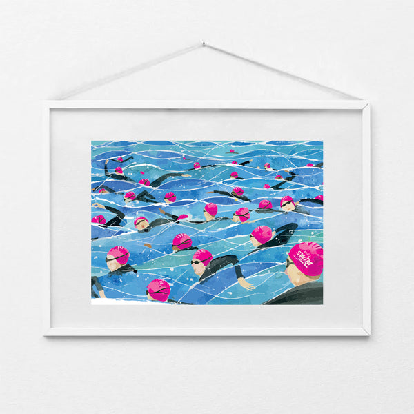 Framed A4 art print of the Great North Swim mass start, showing swimmers in pink swim caps and wetsuits in open water. Print shown in a white frame (not included).