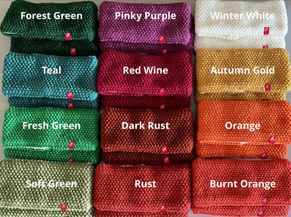 A grid of twelve knitted pheadbands in autumn/winter colours, labeled with names like Forest Green, Pinky Purple, Winter White, Teal, Red Wine, Autumn Gold, Fresh Green, Dark Rust, Orange, Soft Green, Rust, and Burnt Orange. Each item has a small red Andrea Hall tag attached.