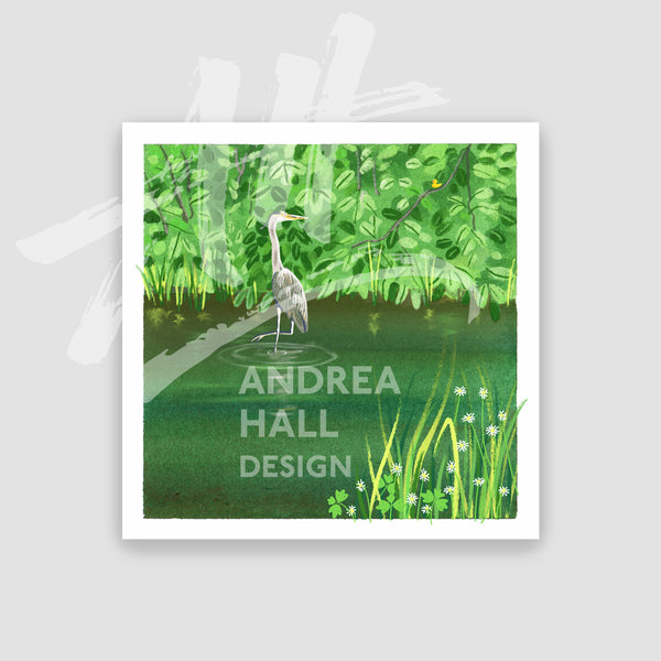 A square art print featuring a painted green water scene with a grey heron standing in shallow water, grasses with small white flowers. The print is centered on a light gray background.