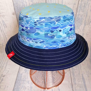 Reversible swimmer's festival bucket hat featuring a new waves design