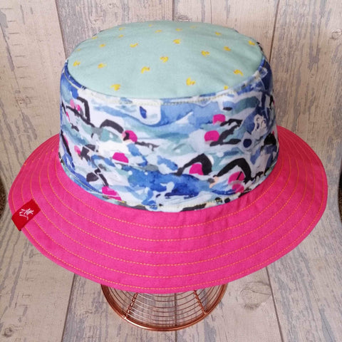 Pink, reversible festival bucket hat with swimmers