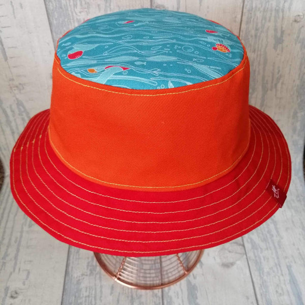 Reversible swimmer's festival bucket hat in orange, navy and turquoise