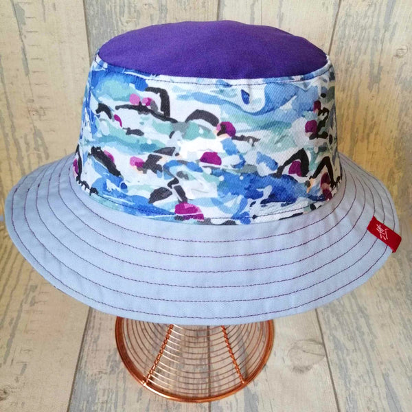 Reversible festival bucket hat with purple swim caps design
