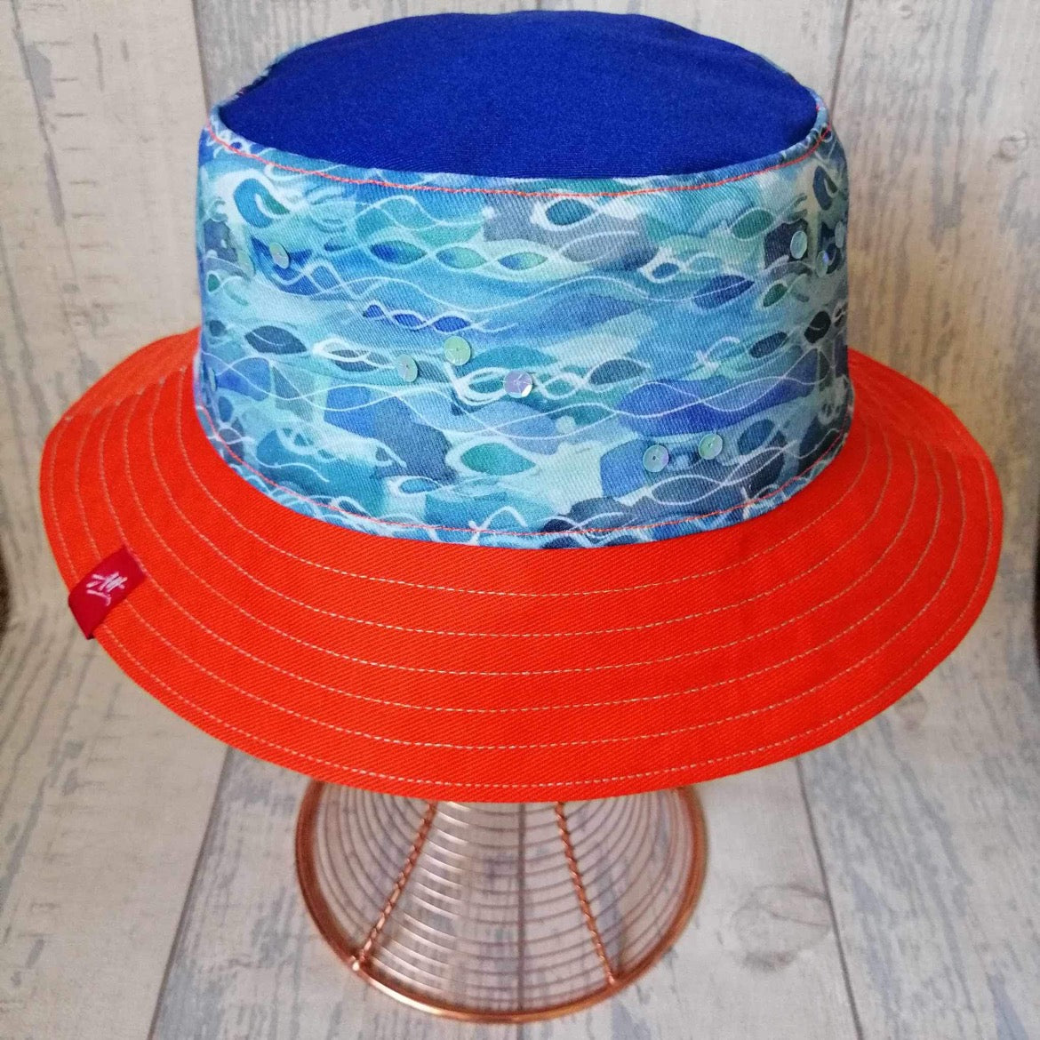 Reversible swimmer's festival bucket hat in blue, orange and neon yellow