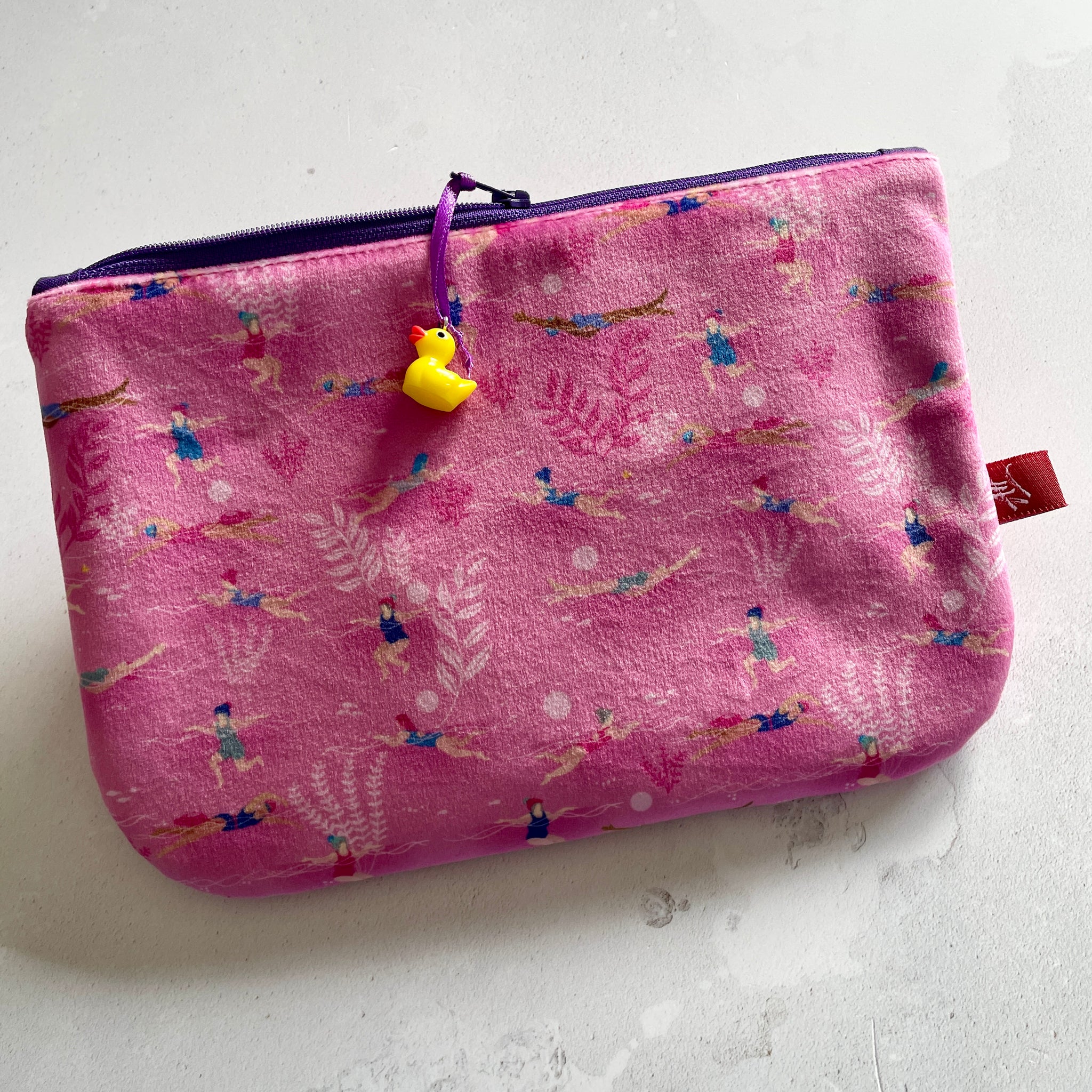 Small illustrated pink velvet pouch. Ladies Wot Swim design