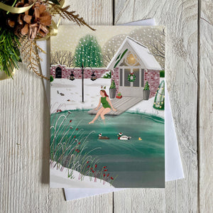 Christmas card with illustration of wild swimmer getting into her garden pond. Card with white envelope and a touch of Christmas decoration