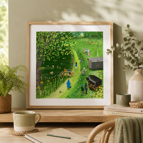 A framed art print featuring a whimsical, colorful illustration of Swillington Wilds with people, displayed on a wooden shelf in a cozy, natural styled room setting.