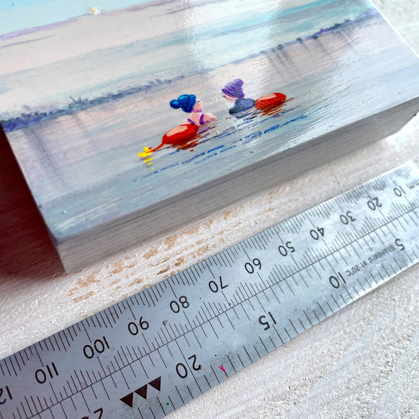 Small painting of wo swimmers in a misty lake with a ruler for scale.