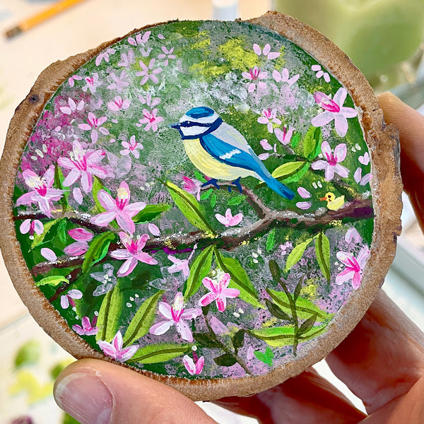 Close-up of Blue Tit with Blossom showing the hand-painted blue tit, pink flowers and detailed foliage on natural wood.
