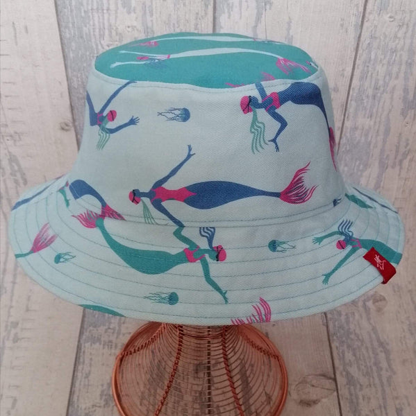 Reversible festival bucket hat. Blue and turquoise Swimming Mermaid design