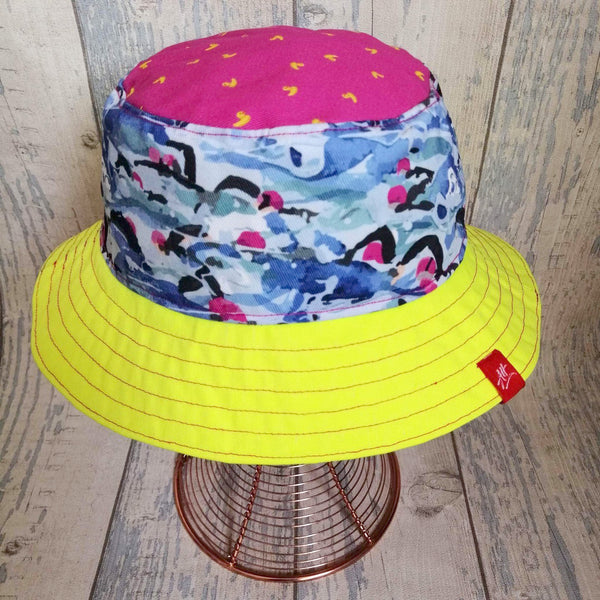 Reversible swimmer's festival bucket hat in pink and neon yellow