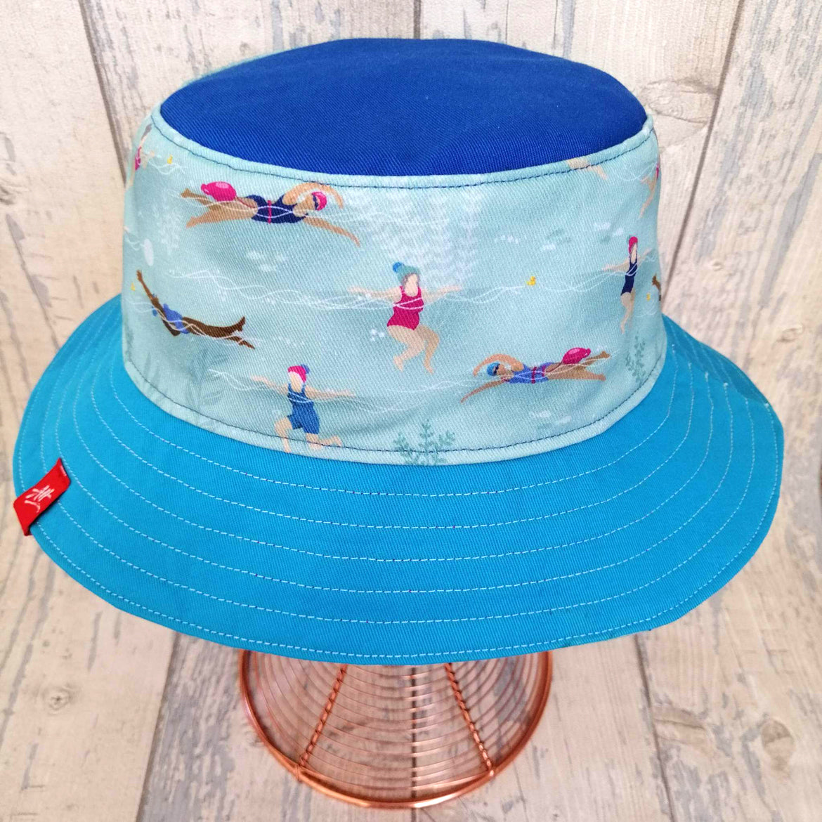 Reversible swimmer's festival bucket hat in all the blues with little swimmers