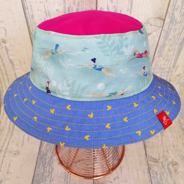 Reversible festival bucket hat in yellow, pink, mauve and duck-egg, with swimmers