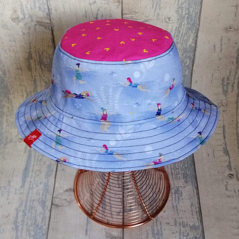 Reversible festival bucket hat with swimming ladies design
