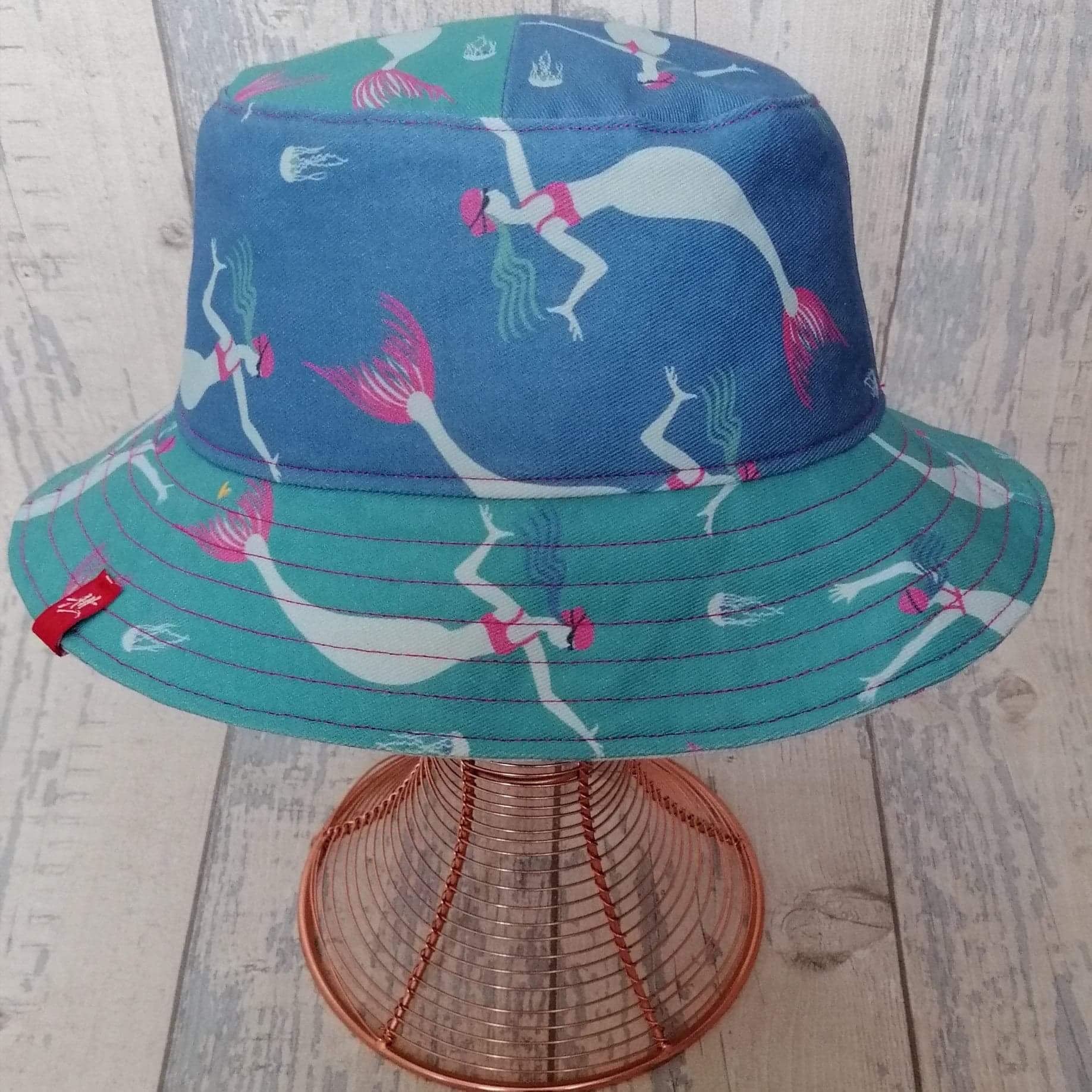 Reversible festival bucket hat. Blue and turquoise Swimming Mermaid design with half-and-half crown