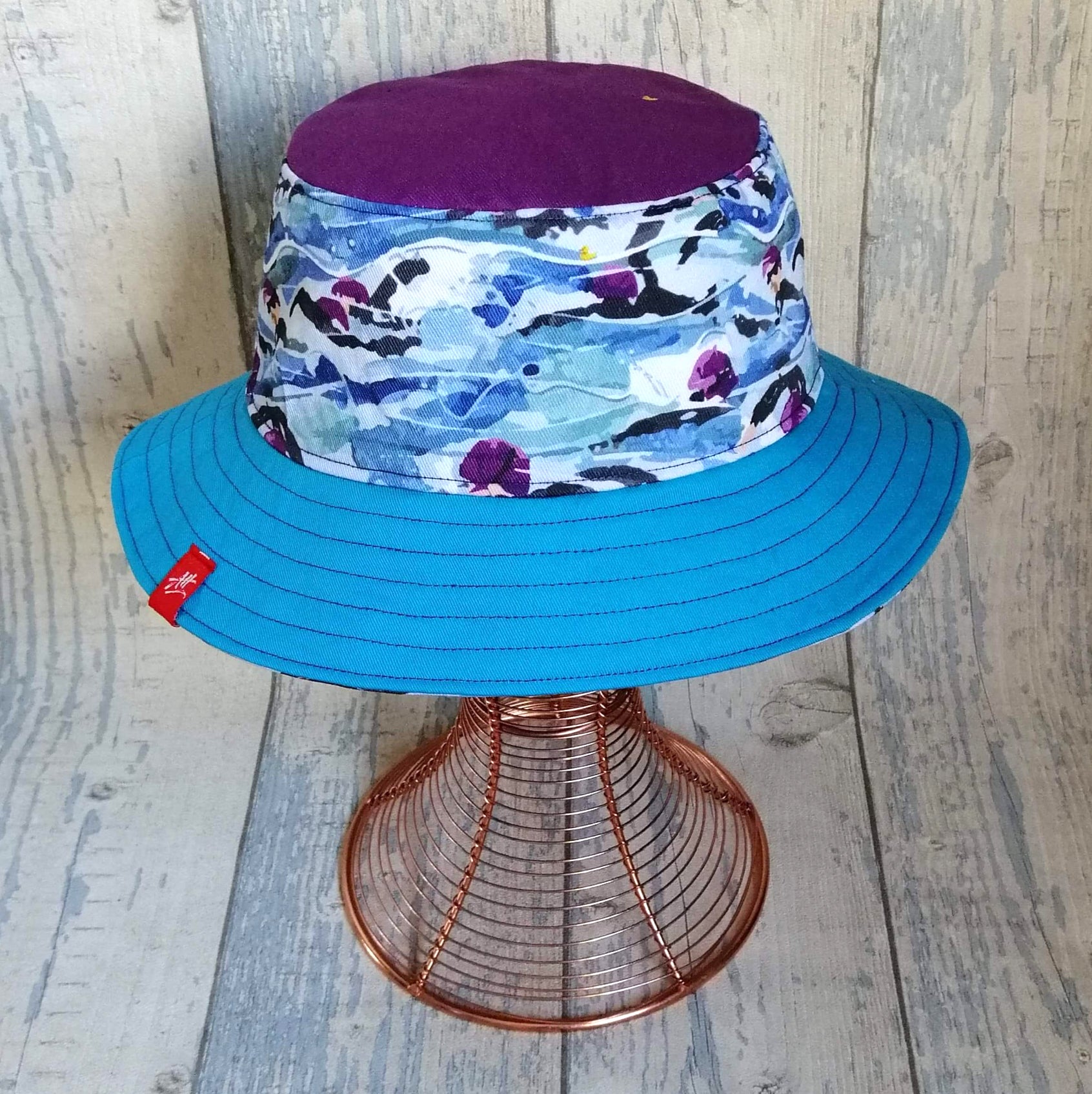 Reversible festival bucket hat with purple Mass Start design with blue brim